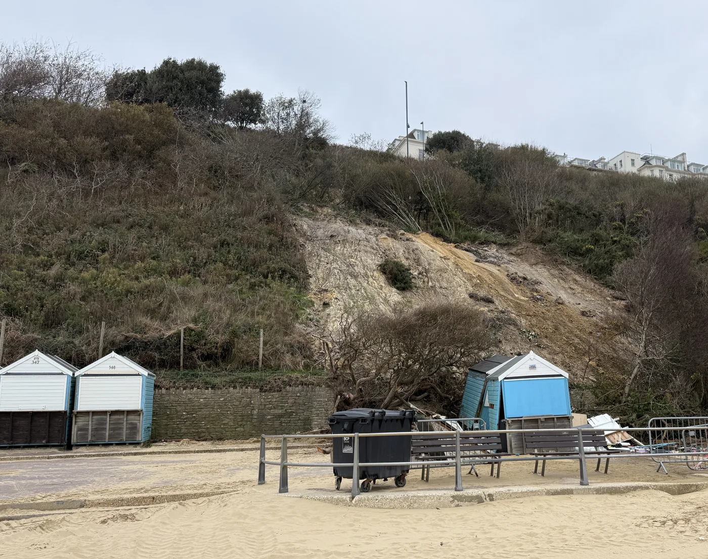 The West Cliff slip above West Undercliff Promenade, with a displaced beach hut at its foot. The picture does not show the site as it is today.